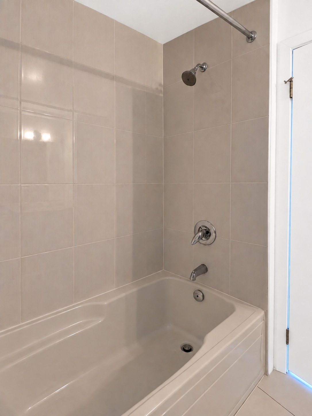 Main bathroom tub & shower. Planned paint preview · AI visualization. A full bathtub and shower with chrome fixtures.